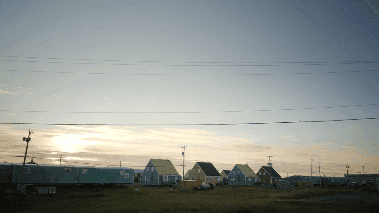 Sun rising over houses