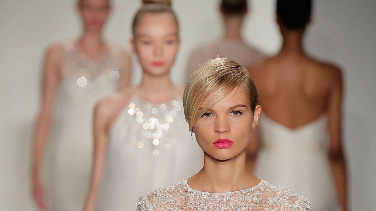 View of a white lace wedding dress exhibited in the Balenciaga