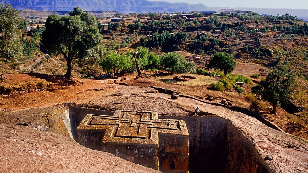 Priest in Bet Danaghel Church holding the Cross of King Lalibela. The  rock-hewn churches of Lalibela make it one of the greatest  Religio-Historical sites not only in Africa but in the Christian