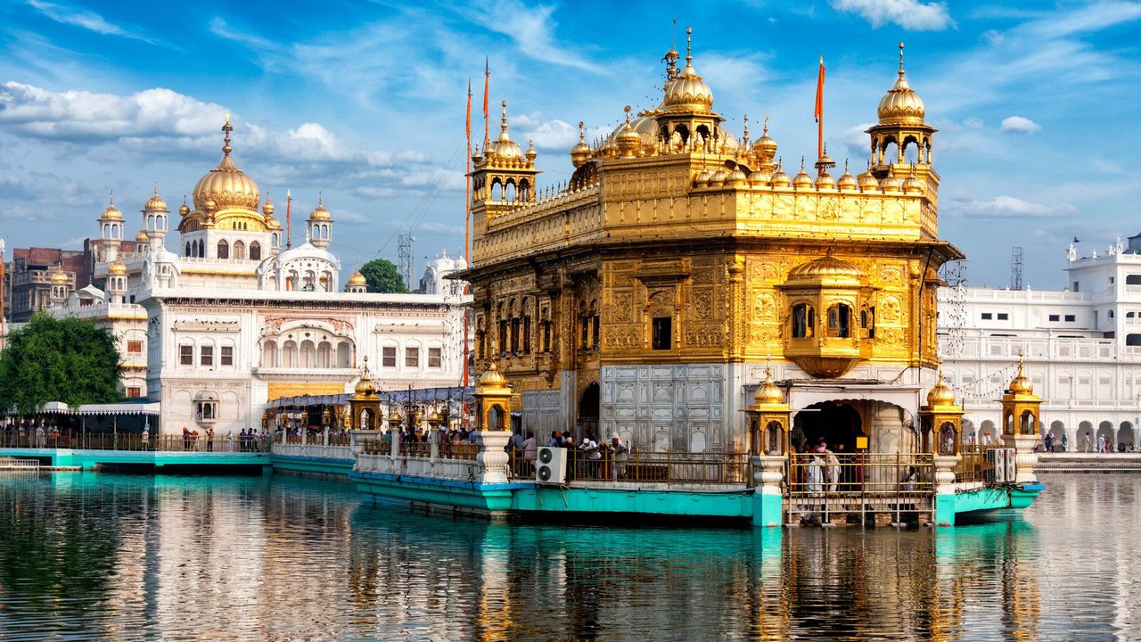 A cook in the Golden Temple cooks in an extremely large pot