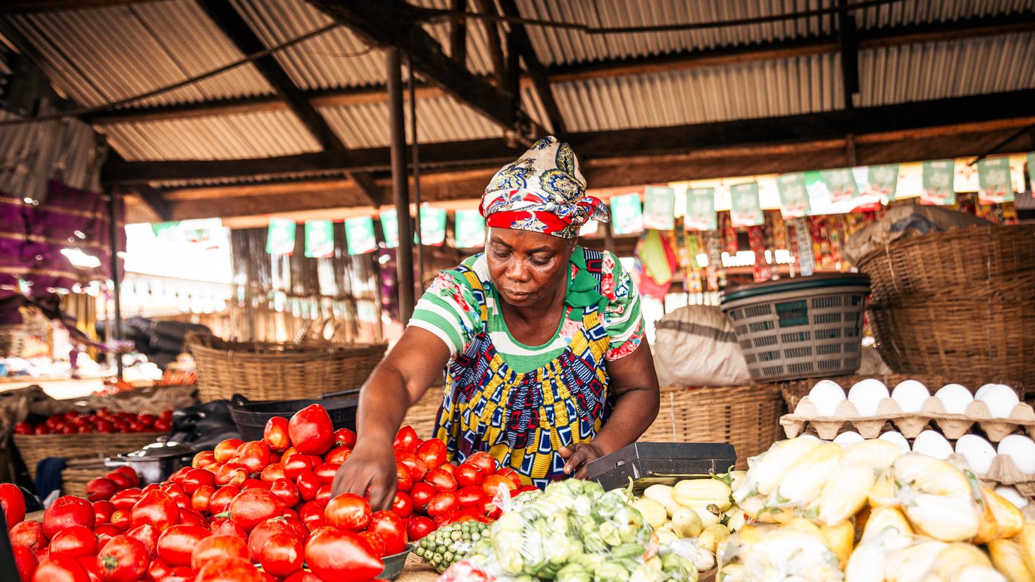 Woman sorting produce at market Woman sorting produce at market