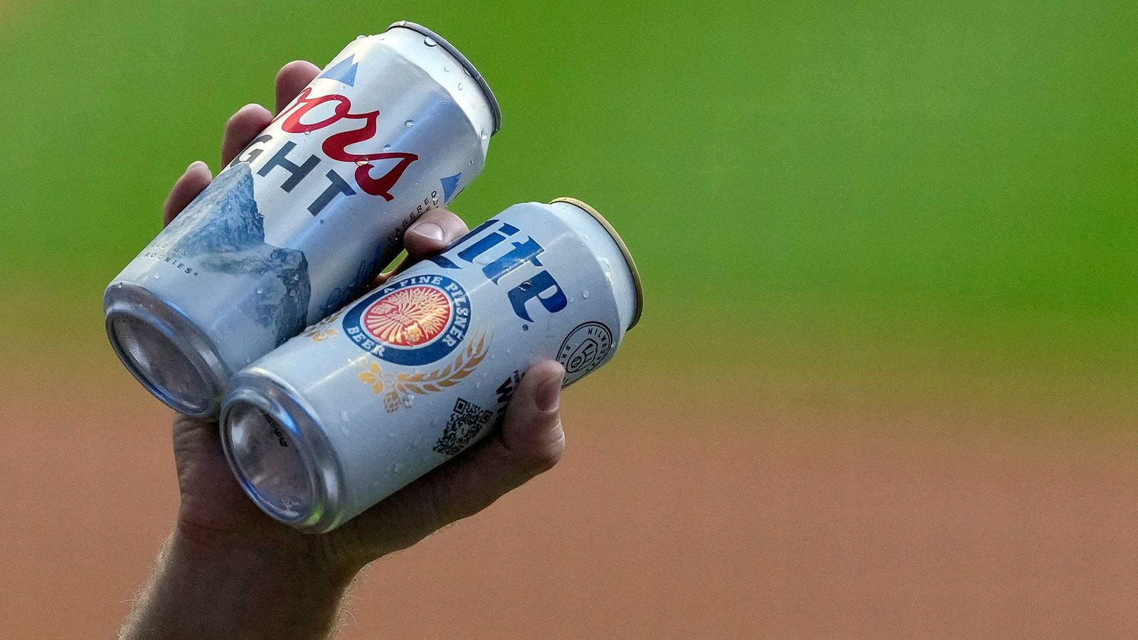 Coors and Miller Light cans at a baseball game