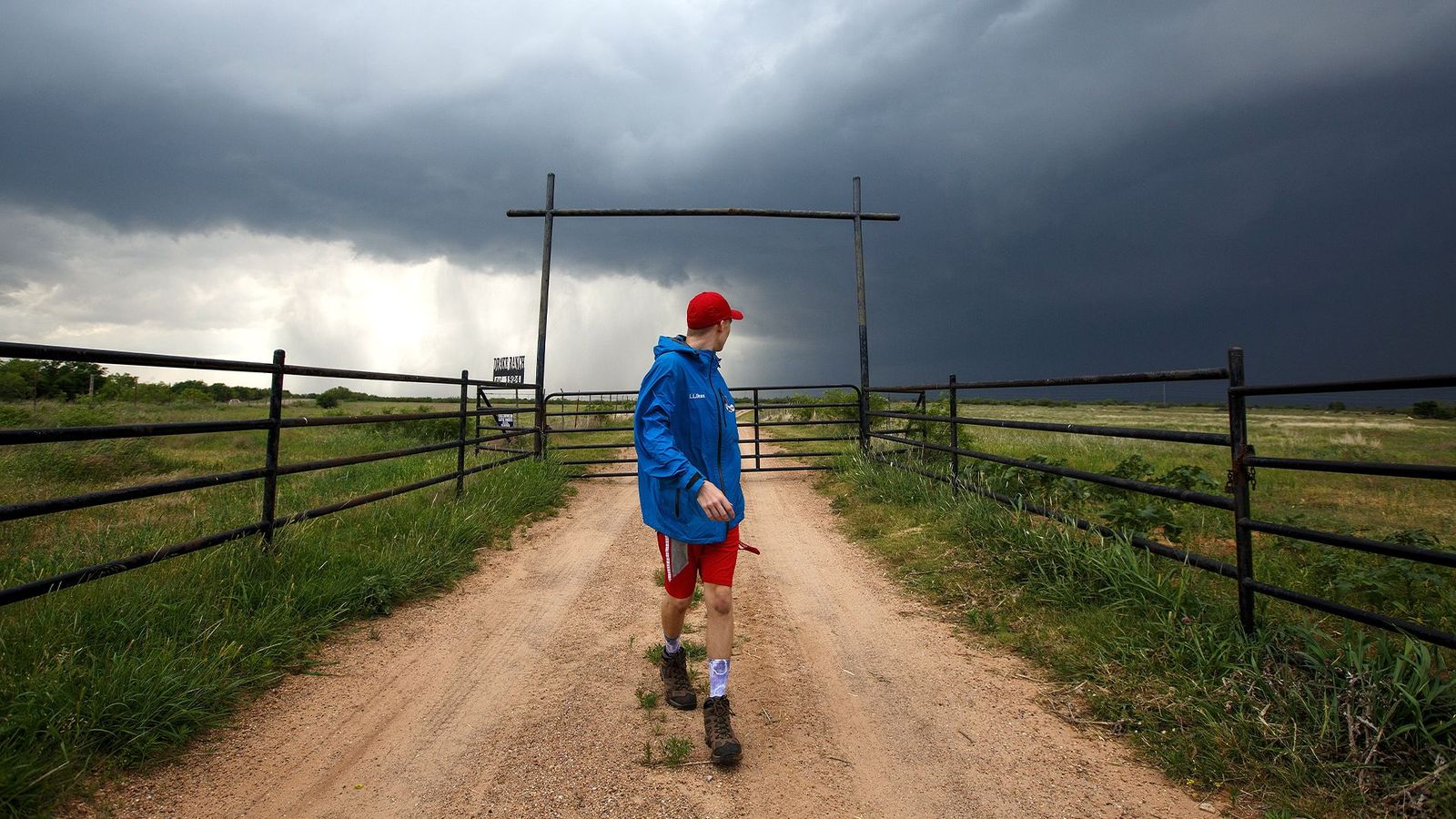 A researcher tracking tornadoes turns to watch a supercell thunderstorm in Texas (Credit: Getty Images)