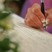 Woman signing the marriage registry - file image thumbnail