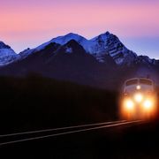 File image of a train travelling past mountains are dawn thumbnail
