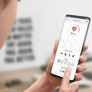File image of a woman looking at her vital signs on her phone thumbnail