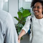 Young woman shaking hands with a colleague thumbnail