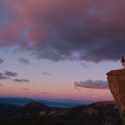 File image of a man on a cliff at sunset thumbnail