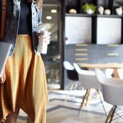 Woman carrying coffee and laptop heading to work thumbnail