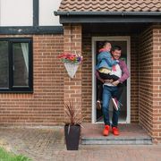 Father carries his daughter out of the house thumbnail