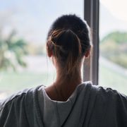 Woman looking out of a window thumbnail