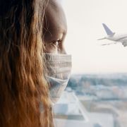 Worried woman watching a plane taking off thumbnail