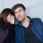 A woman whispering to a man thumbnail