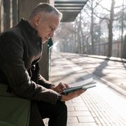 Man reading book while commuting thumbnail