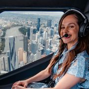 Melanie Zanetti in a helicopter overlooking the city of Brisbane, Australia (Credit: Nic Morely) thumbnail