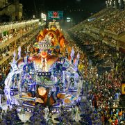 A Carnival parade surrounded by crowds on a street in Rio de Janeiro (Credit: Alamy) thumbnail