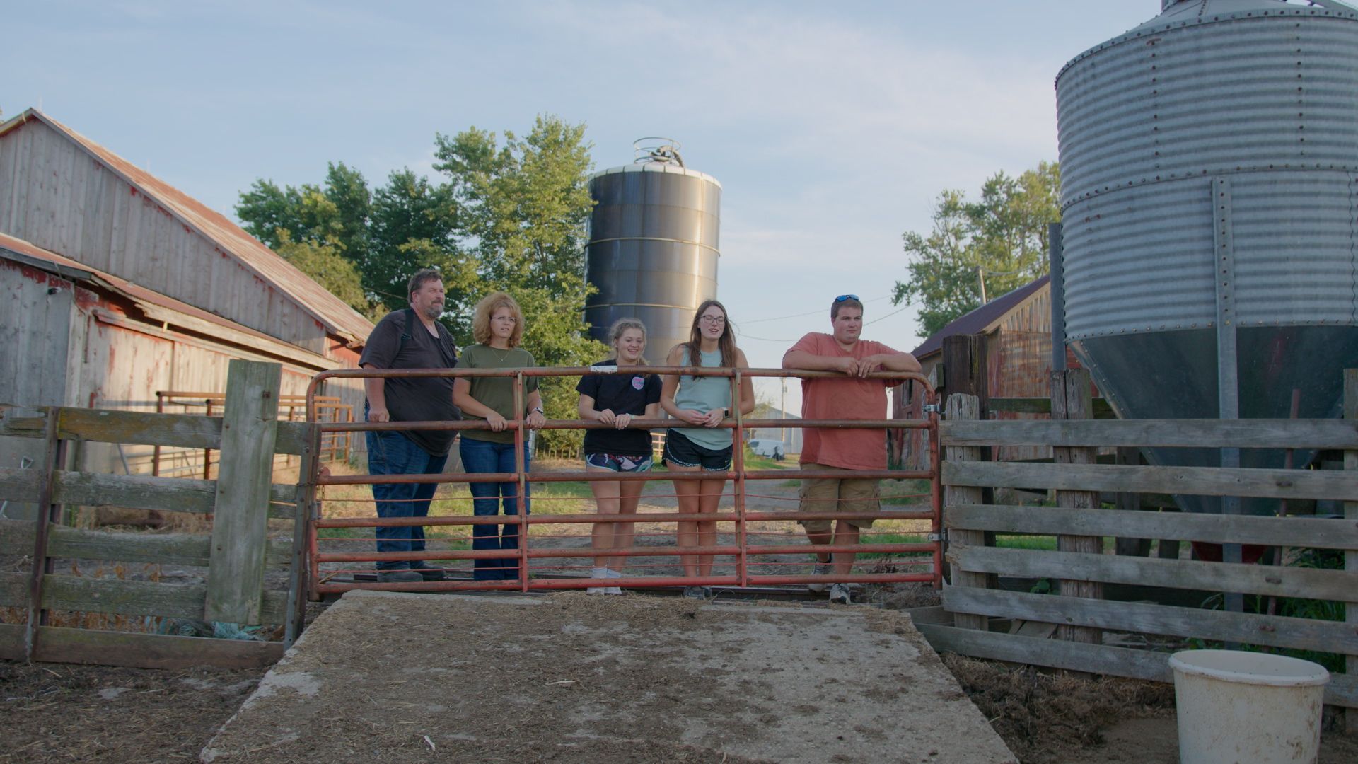 Family looking over farm gate