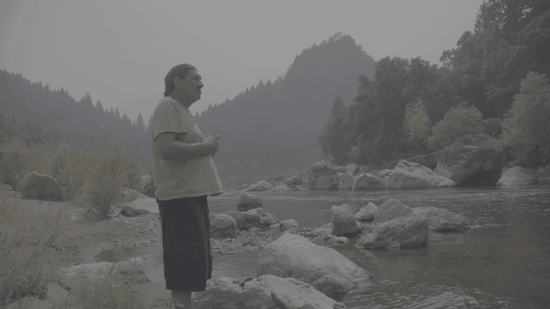 Man looking out at river