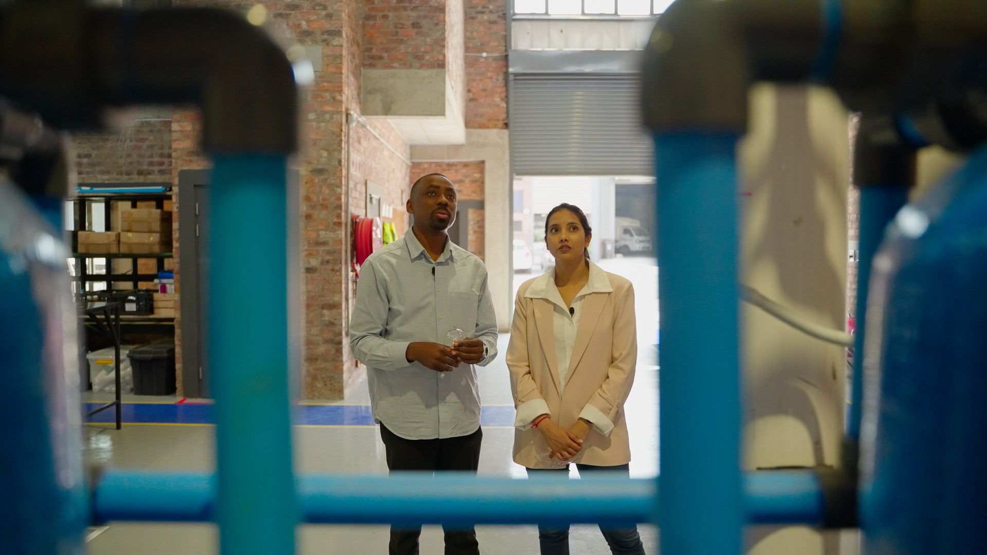 Man and woman looking at machinery
