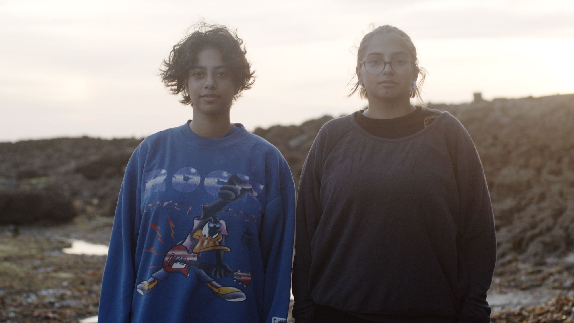 Two people looking into the camera