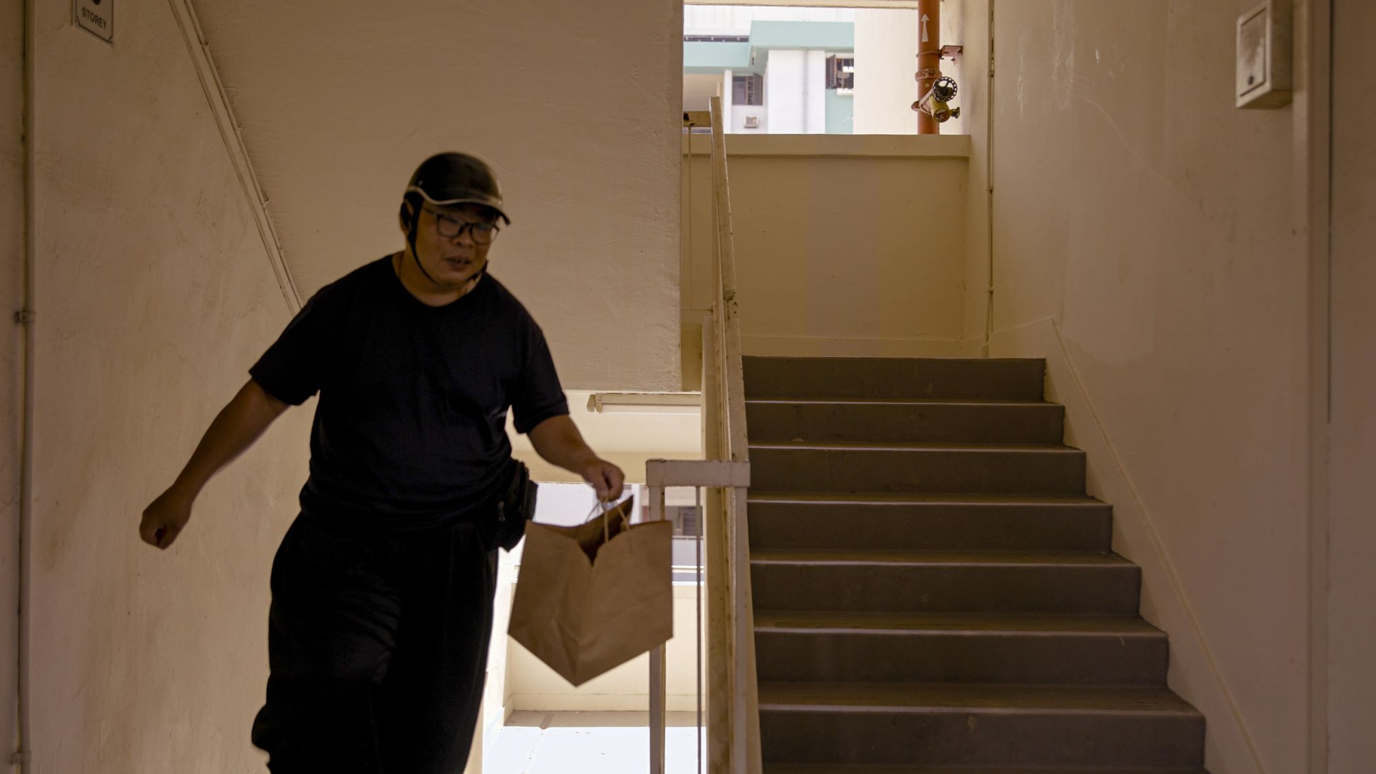 Man walking with delivery upstairs Man walking with delivery upstairs