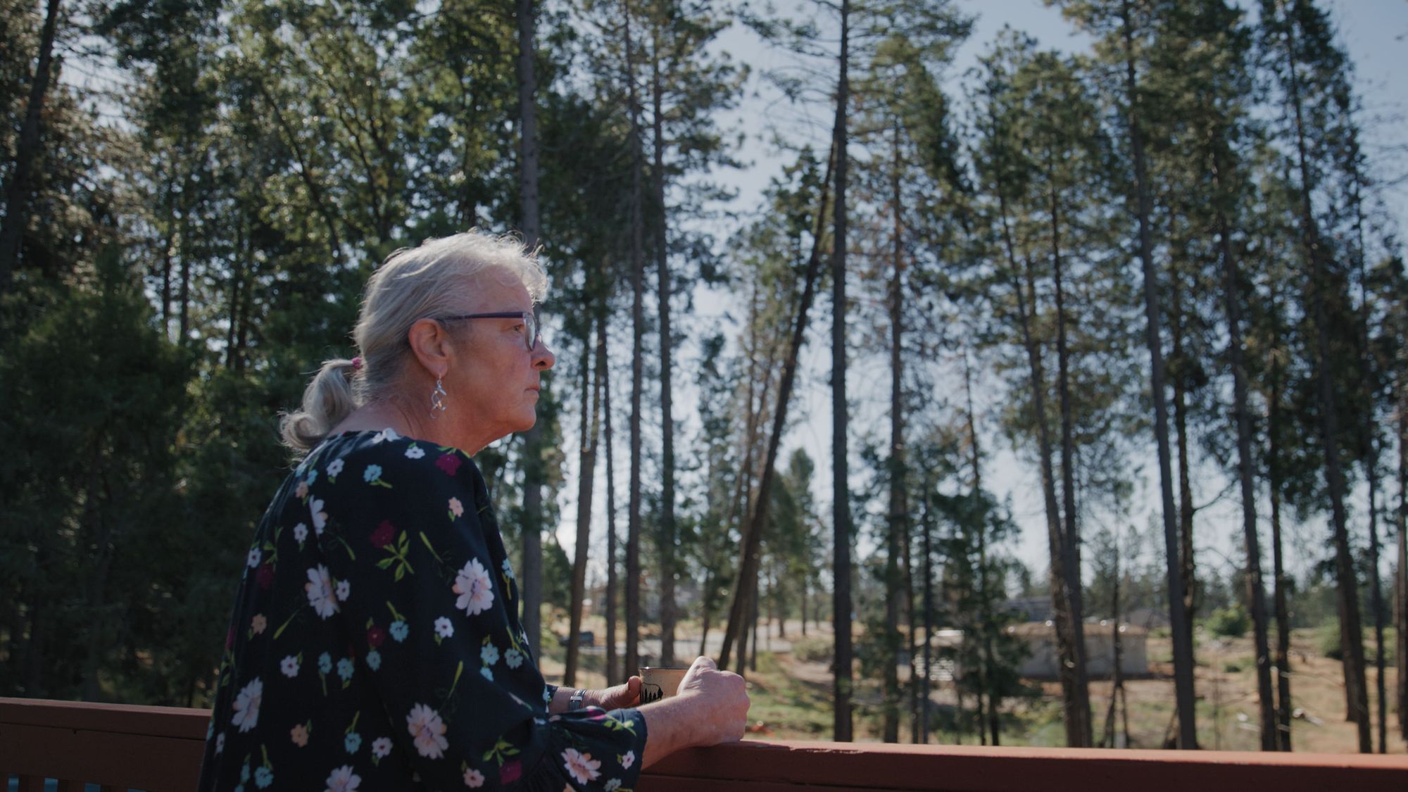 Woman looking out on forest landscape