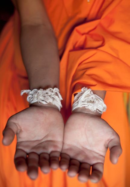 Strings tied around the wrist represent the connection between the person who’s having the life event and the community (Credit: Credit: Steve Whyte/Alamy) Strings tied around the wrist represent the connection between the person who’s having the life event and the community (Credit: Credit: Steve Whyte/Alamy)