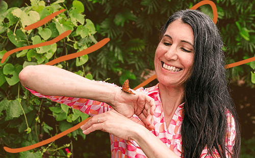 A woman with a butterfly on her hand