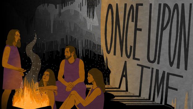 'a group of people sitting around a campfire'