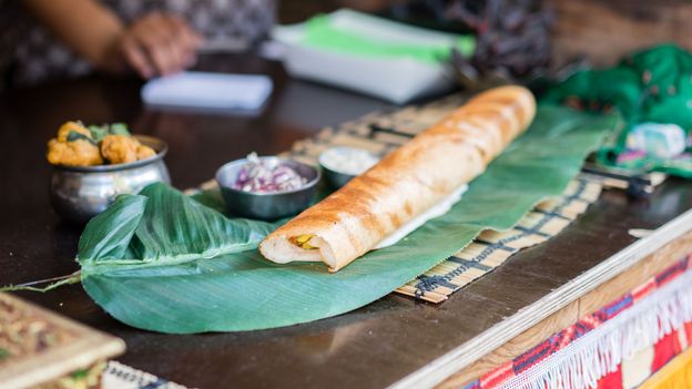 The globally ubiquitous masala dosa is filled with spicy potatoes (Credit: Credit: Nigel Killeen/Getty Images)