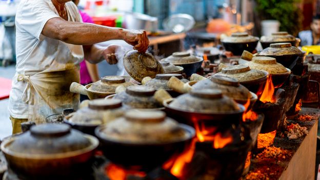 The city-state's once-ubiquitous street food vendors have been moved into hygiene-regulated, covered hawker centres (Credit: Credit: Jimmy Fam/Getty Images)