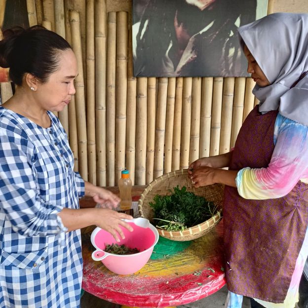 Nafisha Dewi (pictured left), chef at Rasta Café Medewi, uses moringa leaves in many of her dishes (Credit: Mark Eveleigh)