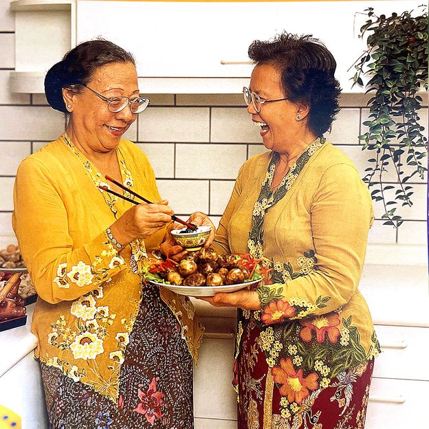 Violet Oon's aunts sharing a plate of hati babi bungkus (fried liver balls) (Credit: Violet Oon/A Singapore Family Cookbook)