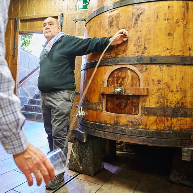 In Basque cider houses, the cider is poured directly into the glass from the barrel (Credit: Javier Larrea/Alamy)