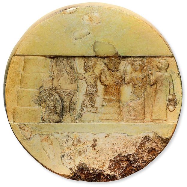 A scene of sacrifice is carved on to one side of this calcite disc; an inscription of Enheduanna appears on the other (Credit: The Penn Museum)