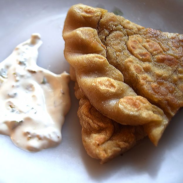 Chap shuro is cut into wedges and eaten with raita (Credit: Aysha Imtiaz)