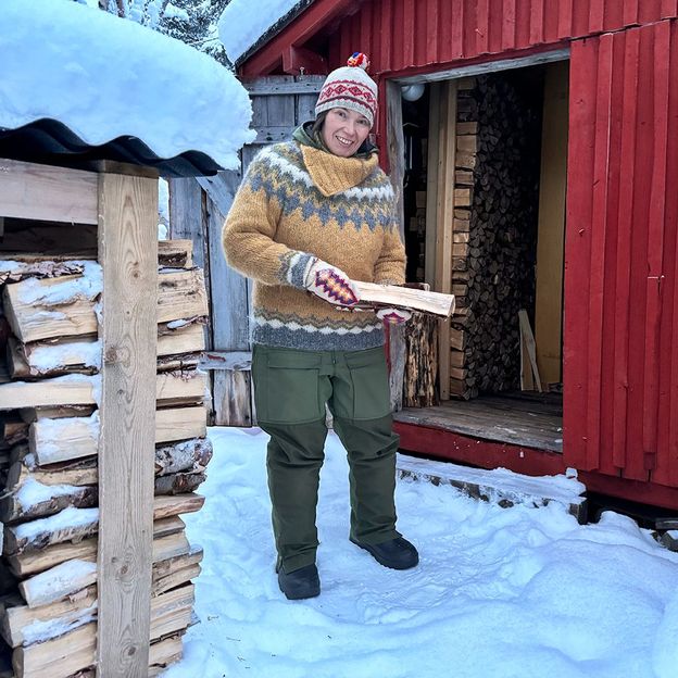 Anna Morottaja has trouble drying the firewood she needs to heat her home due to higher humidity so she has had to build a covered store for it (Credit: Riikka Morottaja)