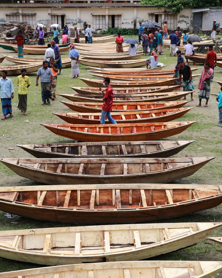 Adapting to waterlogged land stretches back centuries in Bangladesh, such as using traditional boats when roads are inundated (Credit: Getty Images)