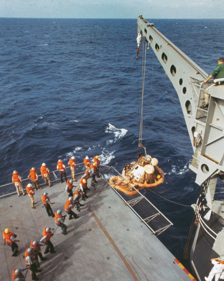 A crane lifts the Apollo 11 capsule onto the ship, but the astronauts were already onboard (Credit: Getty Images)