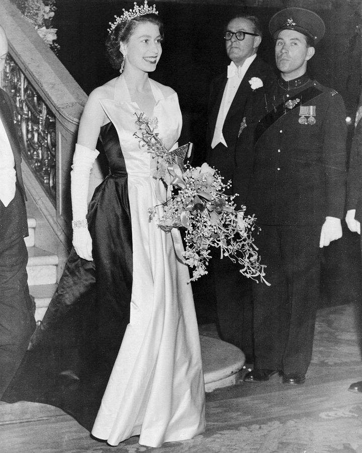 The tuxedo-lapel detail on this gown by Norman Hartnell, worn by the Queen in 1952, was daring for the time (Credit: Getty Images)