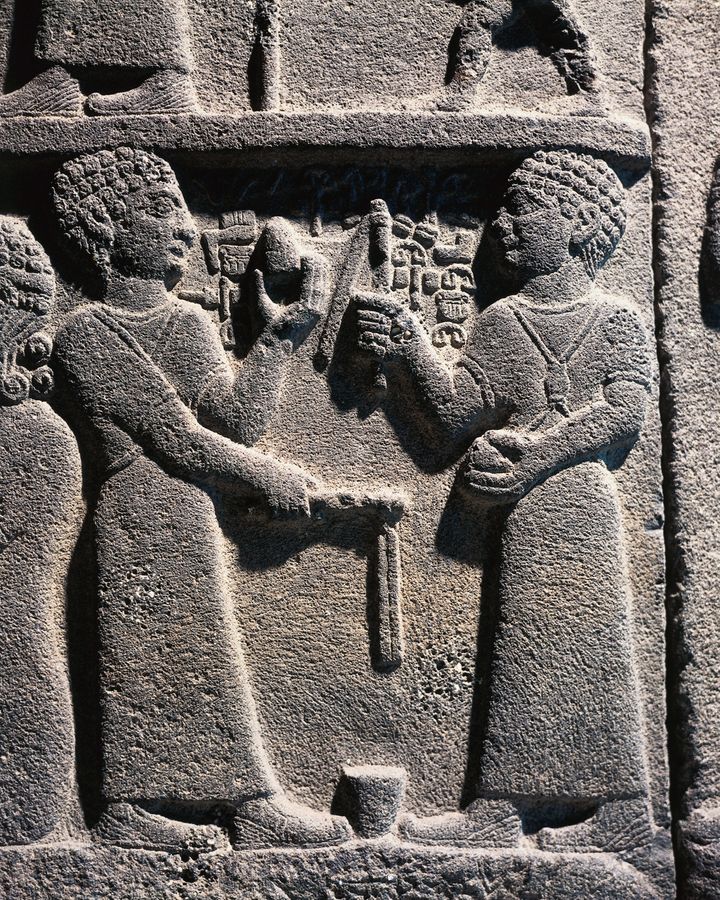 A relief dating to the 9th Century BC in Turkey depicts two men playing with spinning tops (Credit: Getty Images)