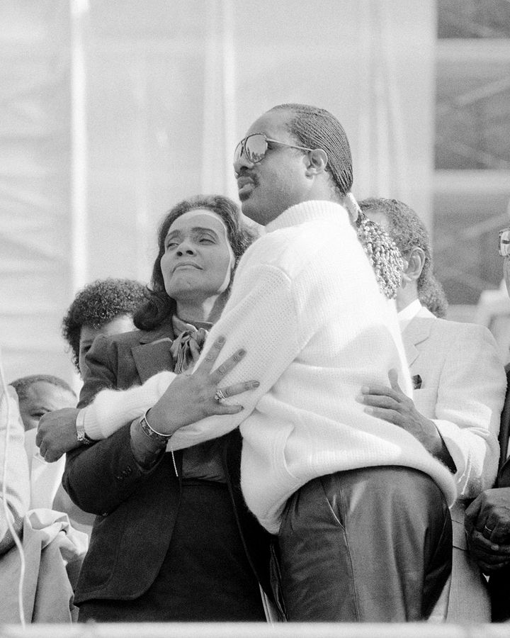 Stevie Wonder and Coretta Scott King embrace after a campaign to make Martin Luther King Day a national holiday bears fruit (Credit: Getty Images)