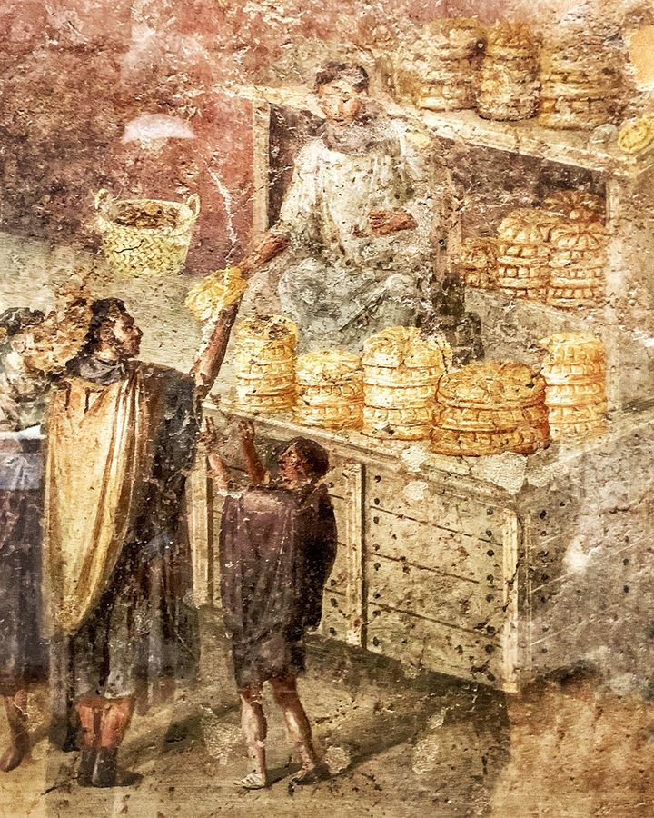 The distribution of bread is depicted in a fresco inside the Casa del Panettiere in Pompeii (VII,3,30) (Credit: Farrell Monaco)