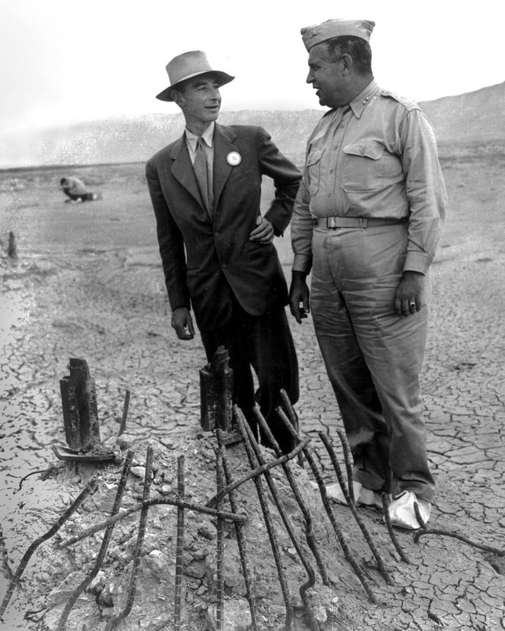 Robert Oppenheimer and General Leslie Groves examine the remains of the steel tower at the Trinity test site (Credit: Alamy)