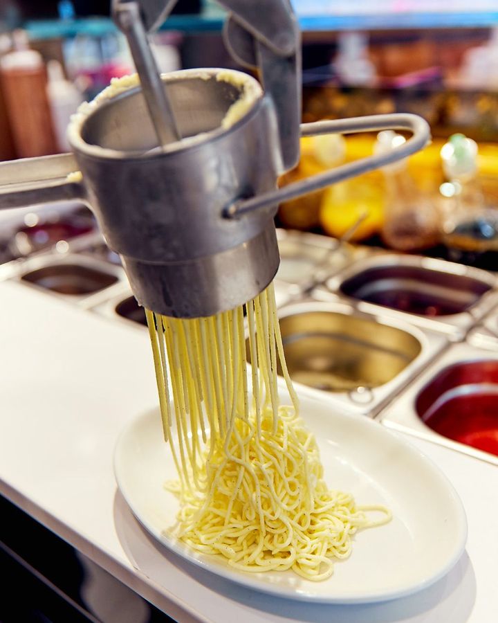 To make the "noodles," the ice cream is pushed through a spätzle press (Credit: Eis Fontanella Eismanufaktur Mannheim)