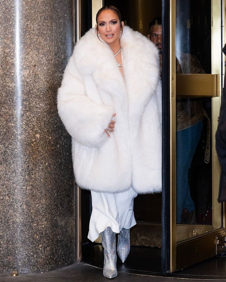 Jennifer Lopez channels the Mob Wife look in glamorous white faux fur (Credit: Getty Images)