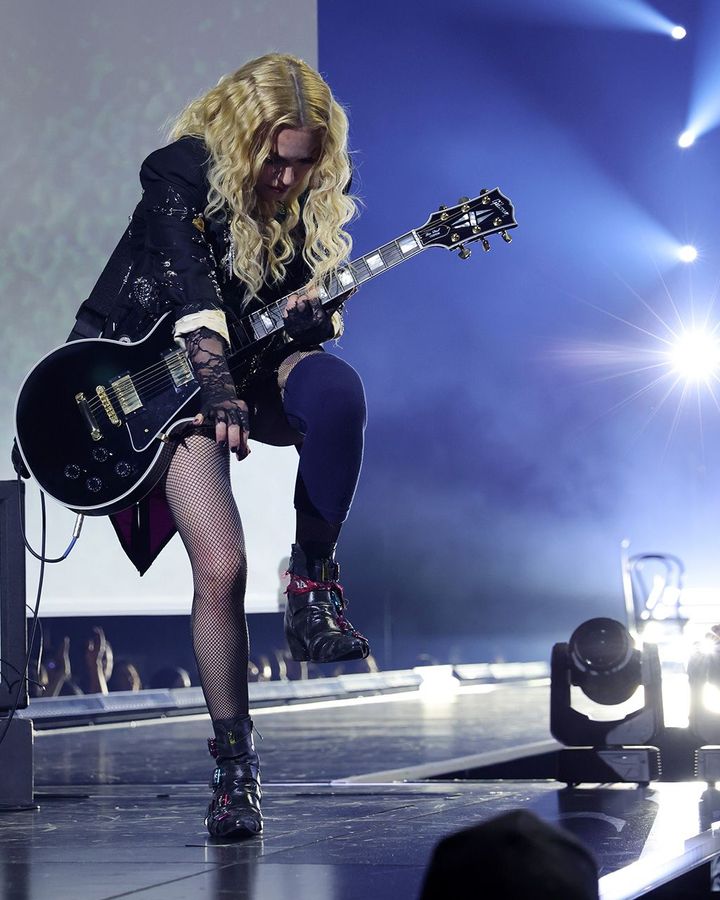 Madonna performing an acoustic version of I Will Survive on her current Celebration tour – one of the show's most moving moments (Credit: Getty Images)