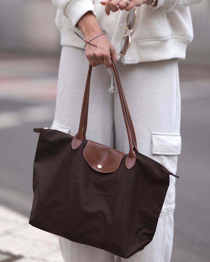 Longchamp's practical Le Pliage is popular among Gen Z because it's lightweight, spacious, and foldable (Credit: Getty Images)