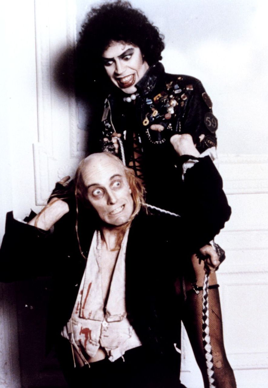 Richard O'Brien (writer of the original stage musical, and co-writer of the film) stars as a servant to Tim Curry's Dr Frank-N-Furter (Credit: Alamy)