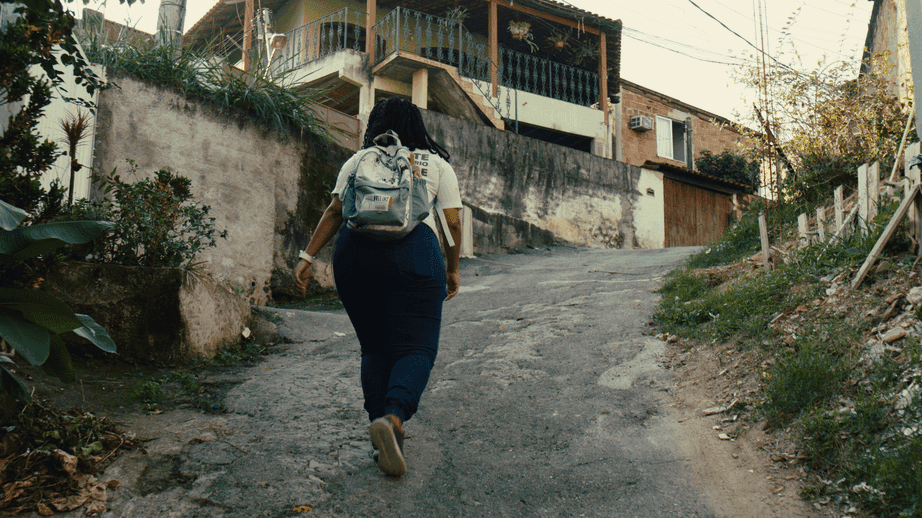 A woman is walking uphill on a path A woman is walking uphill on a path